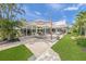 Lush backyard featuring patio with outdoor seating, dining, and well-manicured landscaping at 1186 Center Pl, Sarasota, FL 34236