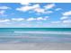 Beautiful beach scene with clear blue skies and gentle waves, perfect for a relaxing day by the sea at 1186 Center Pl, Sarasota, FL 34236