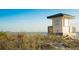 Charming lifeguard station on a sandy beach with sea grass and a beautiful horizon at 1186 Center Pl, Sarasota, FL 34236