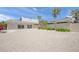 Exterior showcasing a modern home with a gravel driveway, a two-car garage, and a lush green landscape at 1186 Center Pl, Sarasota, FL 34236
