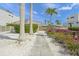 Charming home exterior with a stone walkway, vibrant flowers, and lush tropical landscaping at 1186 Center Pl, Sarasota, FL 34236