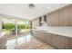 Bright kitchen boasts modern cabinets, stainless steel appliances, and a seamless flow to an outdoor dining space at 1186 Center Pl, Sarasota, FL 34236