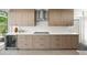 Stylish kitchen with wooden cabinetry, white countertops, and stainless steel appliances, offering a sleek and modern design at 1186 Center Pl, Sarasota, FL 34236