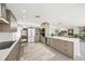Modern kitchen with stainless steel appliances, light wood cabinets, and a view into the adjacent living area at 1186 Center Pl, Sarasota, FL 34236