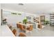 Open-concept living area combines dining and lounging, filled with natural light and modern furnishings at 1186 Center Pl, Sarasota, FL 34236
