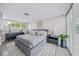 Well-lit main bedroom with sleek furniture, plush bedding, and a tranquil ambiance at 1186 Center Pl, Sarasota, FL 34236