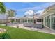 Expansive patio area with plush outdoor seating, a dining table, and lush landscaping at 1186 Center Pl, Sarasota, FL 34236
