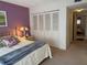 Comfortable bedroom featuring a closet and serene purple accent wall at 1310 Glen Oaks E Dr # 290E, Sarasota, FL 34232
