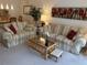 Comfortable living room with plush seating, glass coffee table, and bright decor at 1310 Glen Oaks E Dr # 290E, Sarasota, FL 34232