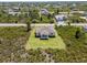 Scenic aerial view of a home nestled among trees in a quiet neighborhood at 13552 Boatbill Ln, Port Charlotte, FL 33981