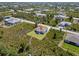High-angle view of house in neighborhood surrounded by trees and other single-Gathering homes at 13552 Boatbill Ln, Port Charlotte, FL 33981