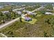 An aerial view of a house surrounded by lush greenery in a residential area at 13552 Boatbill Ln, Port Charlotte, FL 33981