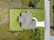 Aerial shot showcasing a property's layout with lush green lawn surrounded by vegetation at 13552 Boatbill Ln, Port Charlotte, FL 33981