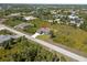 Aerial view of home surrounded by a mix of trees and shrubs in neighborhood at 13552 Boatbill Ln, Port Charlotte, FL 33981
