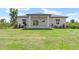 Spacious backyard featuring lush green lawn and modern home exterior at 13552 Boatbill Ln, Port Charlotte, FL 33981