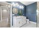 Stunning bathroom with a double vanity, marble countertop, and modern lighting at 13552 Boatbill Ln, Port Charlotte, FL 33981
