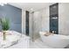 Luxurious bathroom features a soaking tub, glass shower, and modern fixtures at 13552 Boatbill Ln, Port Charlotte, FL 33981