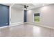 Spacious bedroom featuring modern lighting and a large window with natural light at 13552 Boatbill Ln, Port Charlotte, FL 33981