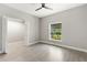 Bedroom featuring wood-look tile flooring, and a bright window with natural light at 13552 Boatbill Ln, Port Charlotte, FL 33981