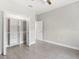 Bright bedroom featuring a closet with built-in shelving and wood-look tile flooring at 13552 Boatbill Ln, Port Charlotte, FL 33981
