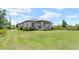 Beautiful single-story home showcasing a spacious lawn and mature landscaping at 13552 Boatbill Ln, Port Charlotte, FL 33981