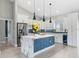 Modern kitchen with a marble island, stainless steel appliances, and elegant pendant lighting at 13552 Boatbill Ln, Port Charlotte, FL 33981