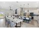 Bright kitchen with white cabinets, a large island, stainless appliances, and a spacious dining area at 13552 Boatbill Ln, Port Charlotte, FL 33981