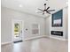 Contemporary living room with high ceilings, modern fireplace, and plenty of natural light at 13552 Boatbill Ln, Port Charlotte, FL 33981
