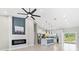 Bright living room with a sleek fireplace, open to the kitchen, and plenty of natural light at 13552 Boatbill Ln, Port Charlotte, FL 33981