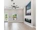 Bright living room features modern fireplace, large window, and stylish ceiling fan at 13552 Boatbill Ln, Port Charlotte, FL 33981