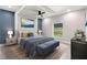 Comfortable primary bedroom features a ceiling fan, a large window, and stylish décor at 13552 Boatbill Ln, Port Charlotte, FL 33981