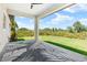 Covered patio with a modern design, ceiling fan, and views of the backyard at 13552 Boatbill Ln, Port Charlotte, FL 33981