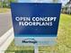 Community sign promotes 'Open Concept Floorplans' by Meritage Homes, emphasizing modern living at 14057 Crutchfield Ct, Parrish, FL 34219
