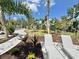 Serene outdoor lounge area with lush landscaping, offering a tranquil retreat for relaxation at 14057 Crutchfield Ct, Parrish, FL 34219