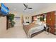 Spacious bedroom featuring a ceiling fan, tv, and warm neutral tones, creating a relaxing retreat at 1410 Livingston Rd, Lutz, FL 33559