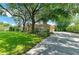 Lovely home with a long driveway, lush lawn, and mature trees at 1410 Livingston Rd, Lutz, FL 33559