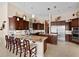 Gourmet kitchen with granite countertops, stainless steel appliances, custom cabinetry, and island seating at 1410 Livingston Rd, Lutz, FL 33559