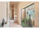 Walk-in shower with spa-like features, including a rain shower head and adjacent greenery at 1410 Livingston Rd, Lutz, FL 33559