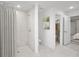 Modern bathroom featuring a walk-in shower with neutral tiling and a shower curtain, providing a clean and stylish look at 16077 Edina Ave, Port Charlotte, FL 33954