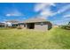 Backyard with lush green grass and covered patio area at 16139 69Th E Ln, Parrish, FL 34219