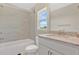 Clean bathroom featuring a bathtub, shower, and a granite-topped vanity at 16139 69Th E Ln, Parrish, FL 34219