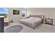 Bright bedroom with modern decor, large windows, neutral tones and soft gray carpet at 16139 69Th E Ln, Parrish, FL 34219