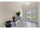 Bright foyer with a decorative glass entry door, stylish console table, and neutral tile flooring at 16139 69Th E Ln, Parrish, FL 34219