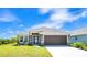 Charming single-story home with a well-manicured lawn, a two-car garage, and inviting curb appeal at 16139 69Th E Ln, Parrish, FL 34219