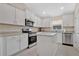 Well-lit kitchen with white cabinetry, granite countertops, stainless steel appliances, and an island at 16139 69Th E Ln, Parrish, FL 34219