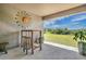 Covered patio with outdoor seating overlooking the backyard at 16139 69Th E Ln, Parrish, FL 34219