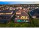 Aerial view of the house with a screened-in pool, situated among other houses and water features at 16626 Paynes Mill Dr, Lakewood Ranch, FL 34211