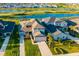 Beautiful aerial view of a home with lush landscaping and a well-maintained lawn in a lakeside community at 16626 Paynes Mill Dr, Lakewood Ranch, FL 34211