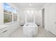 Clean bathroom with separate shower and soaking tub featuring white tile and natural light at 16626 Paynes Mill Dr, Lakewood Ranch, FL 34211
