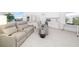 Bright entertainment room with cozy reclining chairs, wet bar, tile floors, and large TV at 16626 Paynes Mill Dr, Lakewood Ranch, FL 34211